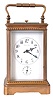 France, for Tiffany & Co., grand sonnerie striking carriage clock with alarm, gilt Corniche variant case with beveled glasses, Arabic numeral white enamel dial with subsidiary alarm chapter, blued steel hands, 8 day quarter striking movement with lever platform, striking the hours and quarters in passing, and repeating on demand