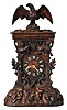 Shelf Cuckoo, carved oak case in the rustic style, the front with oak leaves and acorns, two birds, all surmounted by a large eagle, turned wooden dial with applied Roman numerals, carved bone hands, 8 day, brass time and strike with going barrels and count wheel striking,