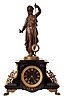 Guilmet, France, mystery clock, black slate case with incised line decoration, foliate side ornaments, and paw feet, surmounted by a patinated female figure, her left hand held aloft, and suspending the pendulum, impulsed through the nearly imperceptible movement of the gilt base on which the she stands, gilt Roman numeral black slate dial, gilt spade hands, 8 days time and strike movement with crank and stirrup escapement, back plate with Guilmets mark and numbered 1958