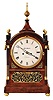 English bracket clock signed, Robert Roskell, Liverpool on the dial, 8 days, time and bell strike, spring driven movement with two fusees in a mahogany veneer Regency period Gothic style case with pierce brass fretwork and inlay and four brass pineapple finials and a painted enamel dial with strike / silent lever above 12 and including a matching shelf.