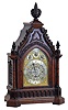 Frederick James Lockwood, West Norwood, London, large bracket clock in the Gothic style, carved oak case with buttress corners supporting turned columns, the molded base with lancet arch blind fret, lancet arch door below a carved lintel, the tympanum with applied, modified foil and hawksbill molding, all topped with foliate carving and decorative finials, case sides with pierced wooden frets, Arabic numeral silvered dial with gilt spandrels, with subsidiary dials for selecting chime tune, mode and regulation, blued steel hands, and substantial, 8 day, 3 train fusee movement, sounding the quarters on four or eight bells and counting the hours on a large gong, the back plate also signed , c1845