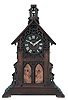 Gordian Hettich Sohn, Germany, "Bell Ringers", walnut, architectural, Gothic style case with stepped base, buttressed corners, and gable with pierced, carved tracery with quatrefoil at top, and finished with a belfry, the front with two lancet arch doors concealing the figures which reveal themselves and "ring" the bells at the quarters, Roman numeral wooden dial, pierced hands, 50 hour, three train brass movement striking the quarters on two bells, and counting the hours on the larger bell, the back plate marked "G.H.S"