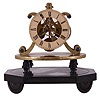 England, after Strutt & Wigston, skeleton clock with epicyclic gearing, 8 day timepiece movement with fusee, well executed five spoke gearing, and nicely finished pierced brass plates, the epicyclic gearing visible between the front plate and the Roman numeral painted dial, blued steel spade hands, the movement mounted to an oval brass plate, the plate with plaque engraved "Wm. Strutt Esqr. Invt", the plate supported on four tapered columns, all on an oval, black slate base with half round turned feet