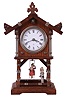 Junghans, Germany swinging doll novelty mantel clock, 8 days, time only, spring driven movment wound from the side of an oak case in the form of a chalet with bisque figures of a well dressed man pushing a young Victorian lady on a swing. The white enamel dial is marked with Junghan's trademark.