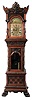 Tall case clock retailed by G.W. Russell, Philadelphia, 8 days, time, strike and chime on 5 tubes, three brass weight driven movement in an ornately carved oak case attributed to R.J. Horner, New York with gargoyle top, fluted and turned corner columns topped by Corinthian capitals on hood, cut out frets, beveled glass doors, carved corner columns, two raised panels on each side, resting on a base with checkerboard panels on sides and front on huge furry paw feet. The engraved brass dial has applied corner spandrels, silvered chapter and second's rings and moon phase.