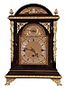 Winterhalder & Hofmeier, Germany, Westminster chime bracket clock, rosewood grained hardwood case with molded base and arched, molded top, and applied gilt ornament, the composite dial with gilt spandrels, silvered chapter ring, and rating control dial in the arch, blued steel hands, 8 day, 3 train quarter chiming fusee movement, sounding on 4 gongs at the quarters, and striking the hours on a larger gong, back plate signed