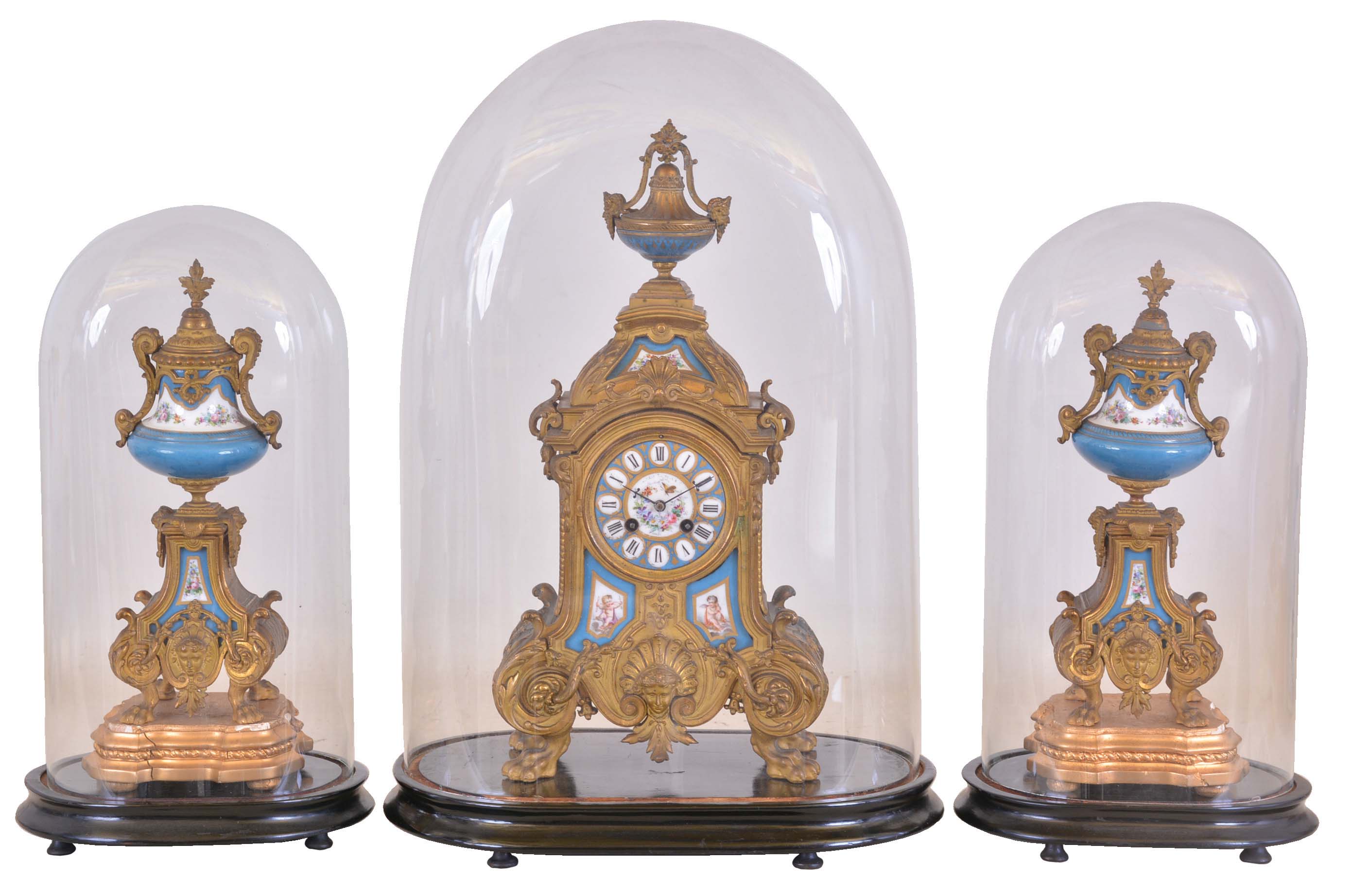 France, mantel clock with garniture, ornate, gilt spelter clock case on paw feet, and with polychrome porcelain panels, Roman numeral porcelain dial, blued steel hands, 8 day time and strike pendule de Paris movement, with matching, porcelain mounted side pieces, each with its own gilt wooden base, all with glass domes — Antique Clocks Price Guide