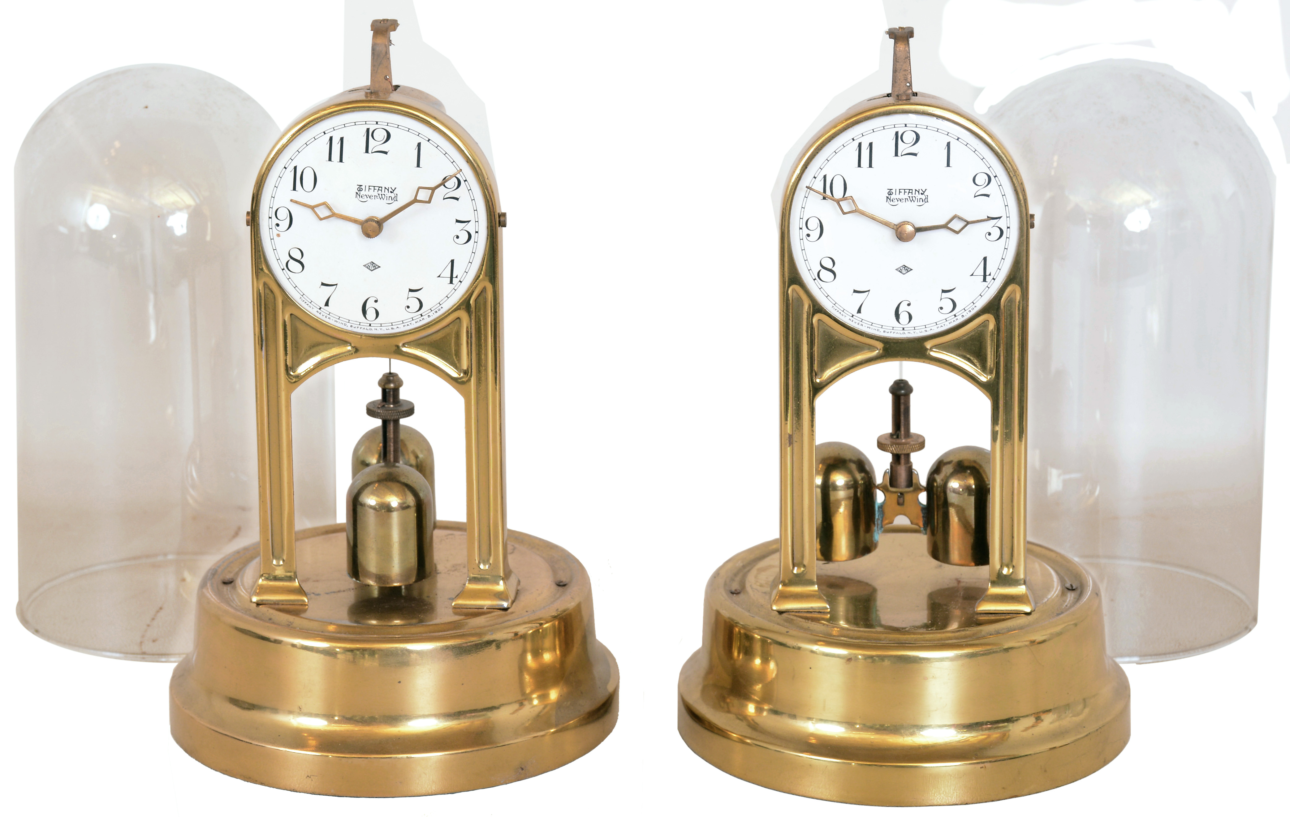 Clocks- 2 (Two) Tiffany Clock Co., Buffalo, NY "Never- Wind" anniversary- style electric clocks with torsion pendulums under domes — Antique Clocks Price Guide