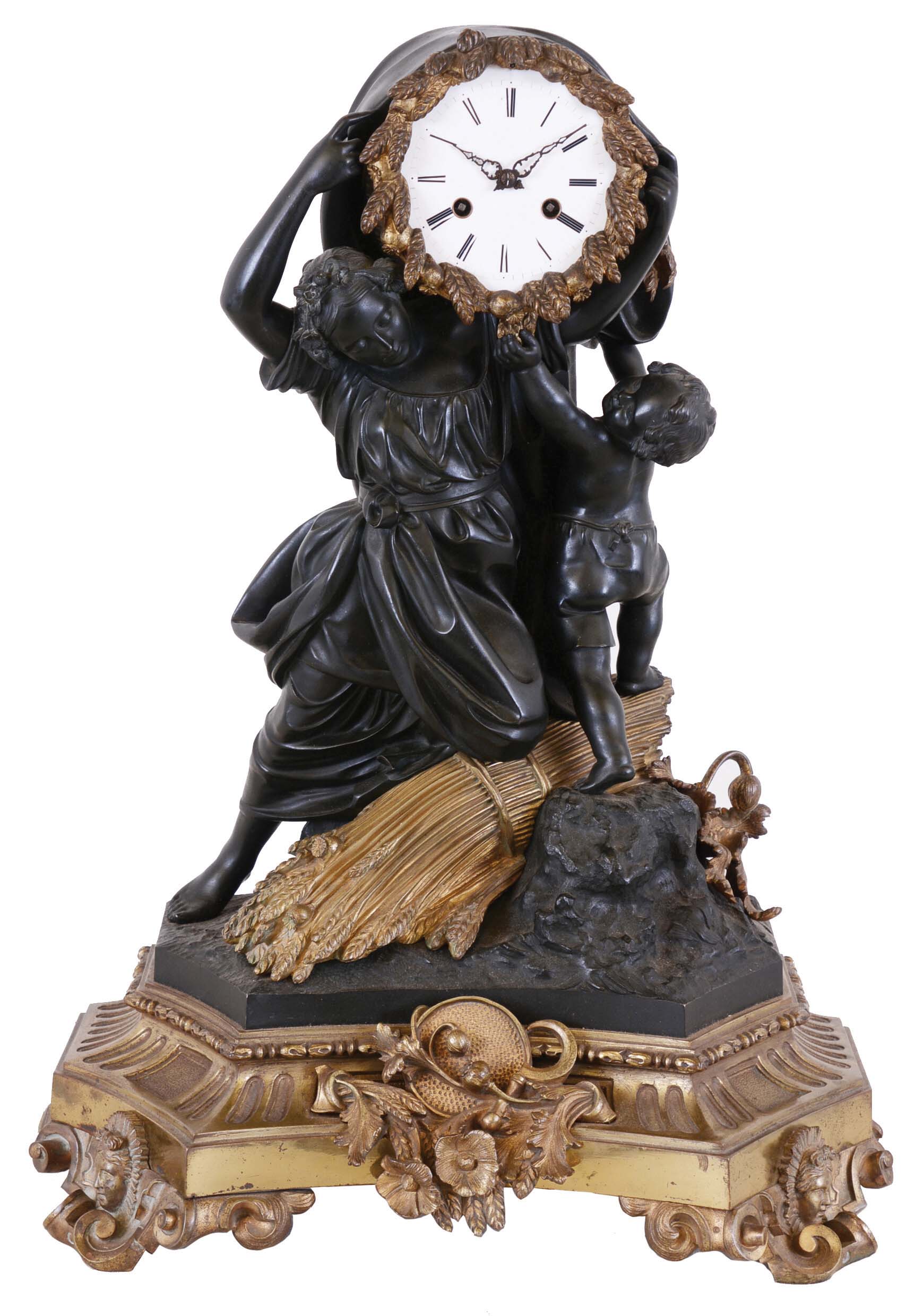 Hemon a Paris, figural mantel clock, gilt and patinated bronze case, the molded base with scroll feet set with Helios masks, the front with trophy, including poppies, acanthus, wheat, and tools of the harvest, and surmounted by a pair of nicely modeled figures; a young woman drawing back a drape covering the clock while the figure of a young boy attempts to stop her, the scene based on earlier clocks depicting Amor and Aurora, and representing the flow of time; the figures before a large, gilt bundle of wheat, and a few poppies, on a patinated, naturalistic ground, Roman numeral, white enamel dial with gilt wheat and poppy bezel, 8 day, time and strike pendule de Paris movement, c1850 — Antique Clocks Price Guide