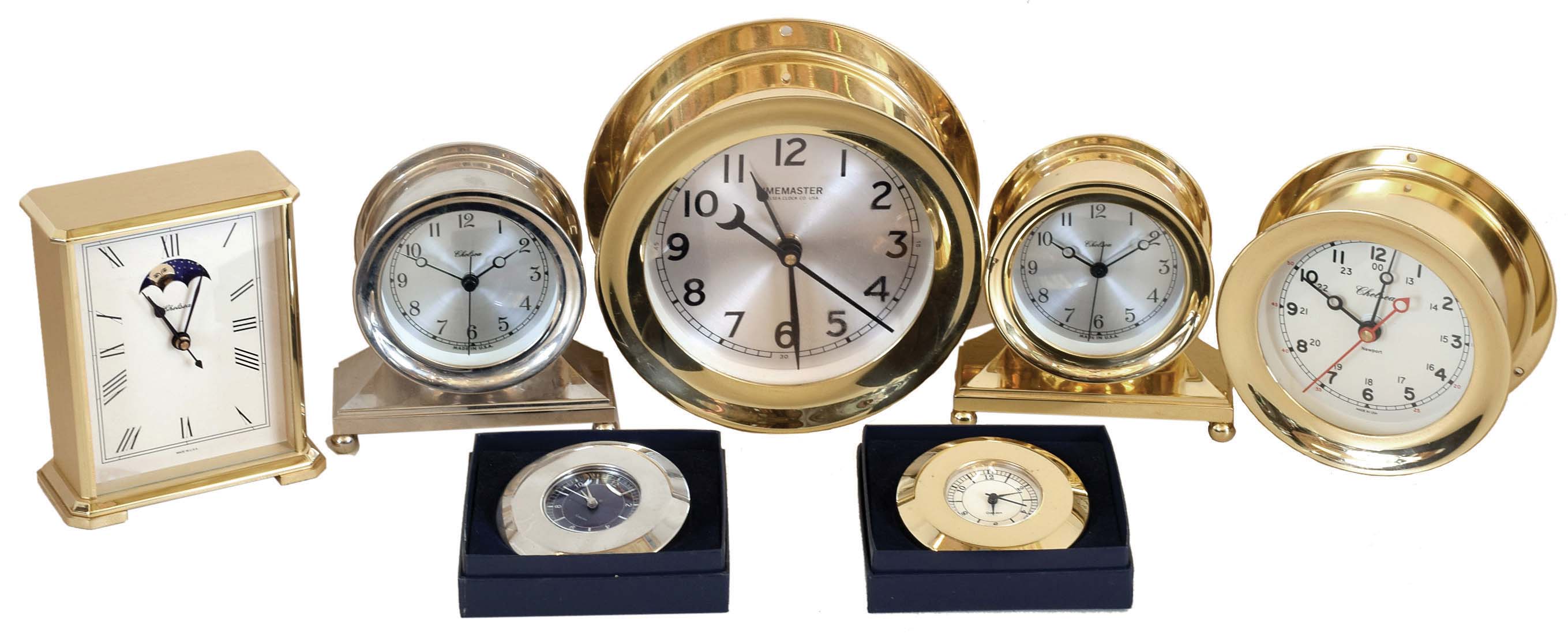 Clocks- 7 (Seven) Chelsea Clock Company metal case quartz movement clocks, new / old stock mostly in original factory packaging: two #20990 Brewster desk clocks in brass and nickel; #20892 "Moonphase in Brass" carriage clock with moon dial; #90886 Constitution Nickel, #20886 Constitution (brass) ; #40069 (?) Newport; #40095 (?) "Timemaster" — Antique Clocks Price Guide