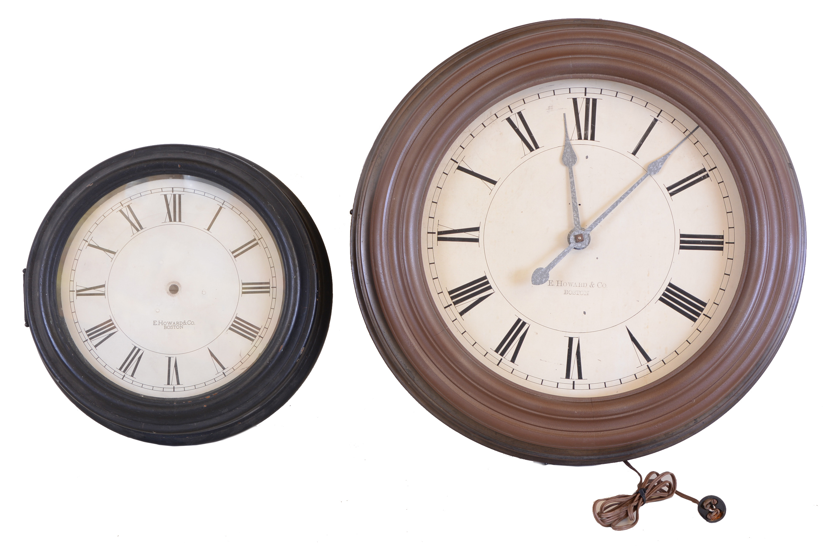 Clocks- 2 (Two) E Howard & Co., Boston, electric clocks: the first with 24 1/2 inch metal case, Roman numeral painted dial, signed nickel plated movement, the other a case only, 17 inch turned wooden case, and Roman numeral painted dial — Antique Clocks Price Guide