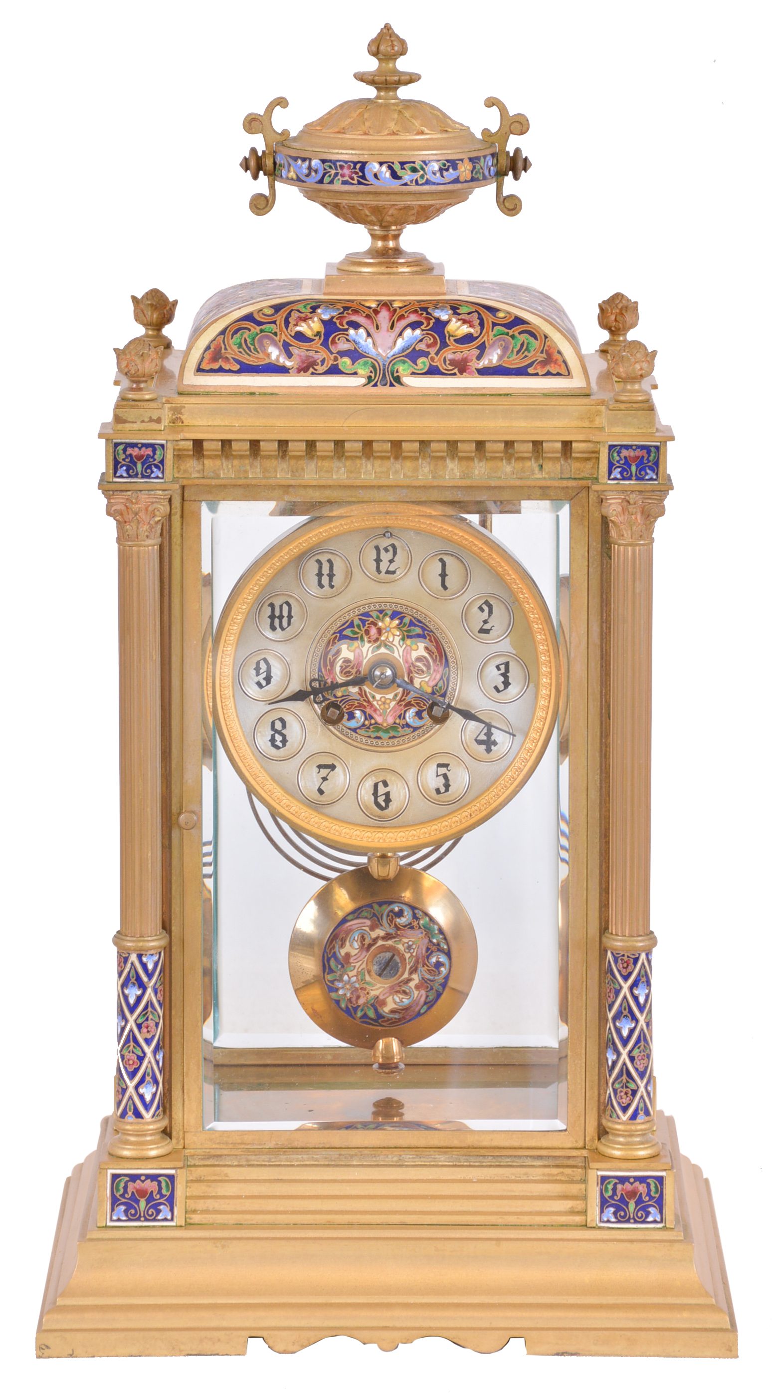 France, crystal regulator, the gilt bronze and champleve enamel decorated architectural case with stepped, molded base, the corners with columns supporting a corbelled cornice, and cushion top surmounted by an urn, silvered concave dial with champleve center, and 8 day, time and strike pendule de Paris movement, brass pendulum also with champleve decoration — Antique Clocks Price Guide