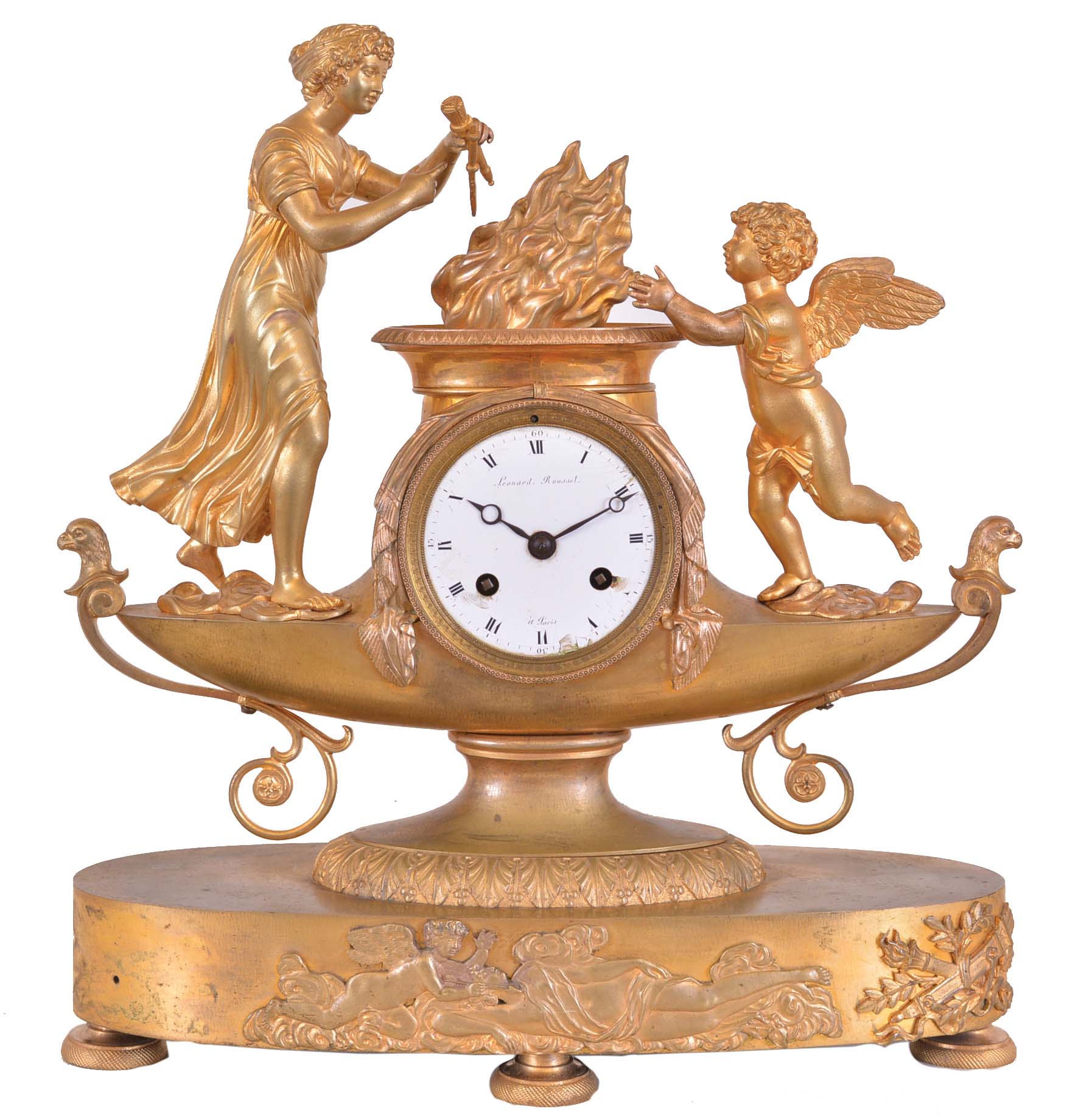 Leonard Rousset, a Paris, a gilt bronze figural mantel clock, the oblong base on engine turned feet with applied cast relief of Cupid and Psyche, supporting the lamp form clock case with figure of Venus casting Cupid's weapons into the fire, signed Roman numeral white enamel dial, blued steel Breguet style hands, 8 say time and strike pendule de Paris movement with silk thread suspension — Antique Clocks Price Guide