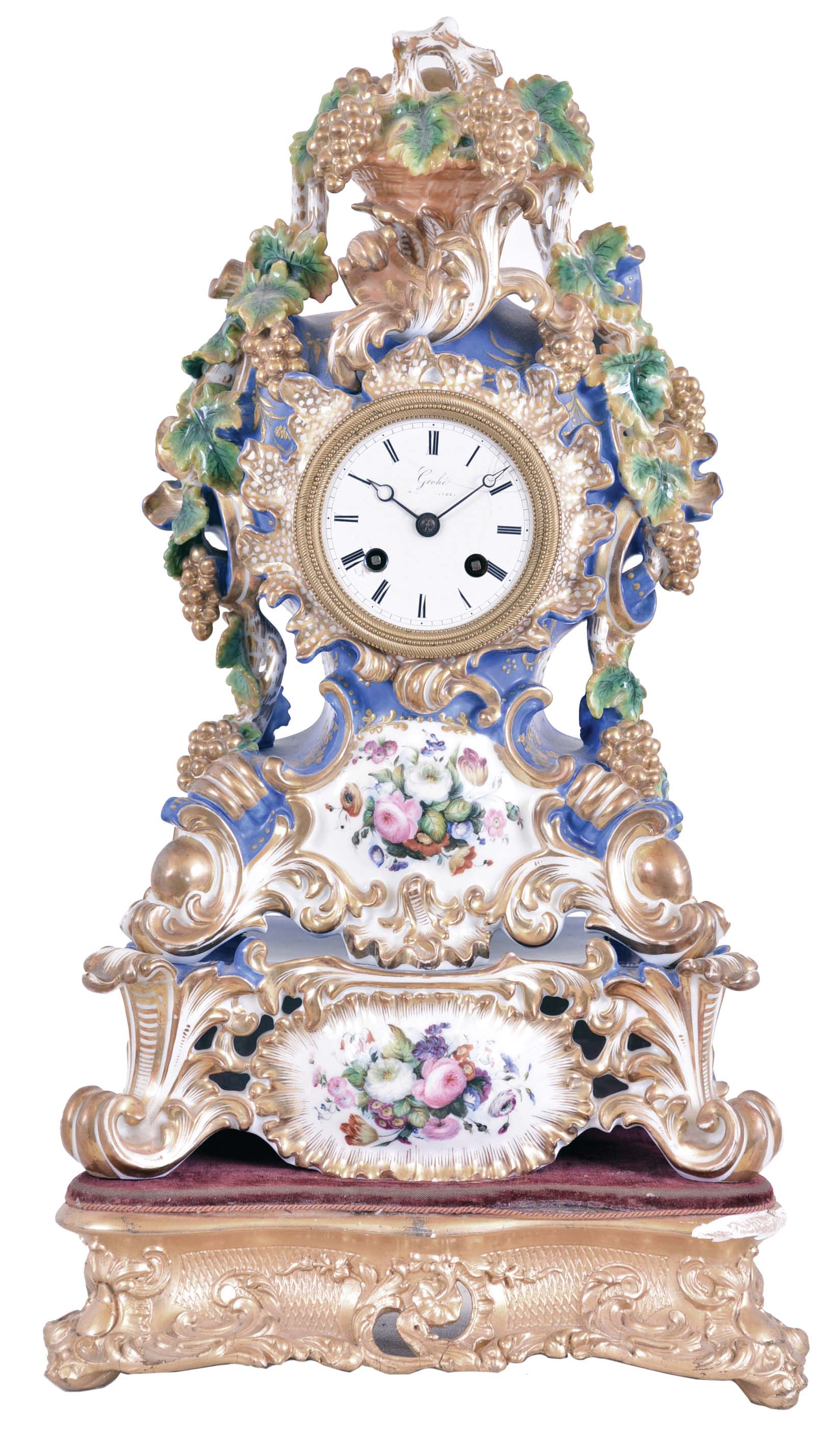 Grohe, a Paris, a three part, rococo style porcelain mantel clock with case by Jacob Petit, the clock and stand both decorated with molded and brightly painted naturalistic ornament, highlighted by bright gilding, all resting on a velvet lined, carved, gilt wooden base, signed Roman numeral white enamel dial, blued steel Breguet style hands, 8 day time and strike pendule de Paris movement with silk thread suspension, stand marked "JP", dial and movement signed — Antique Clocks Price Guide