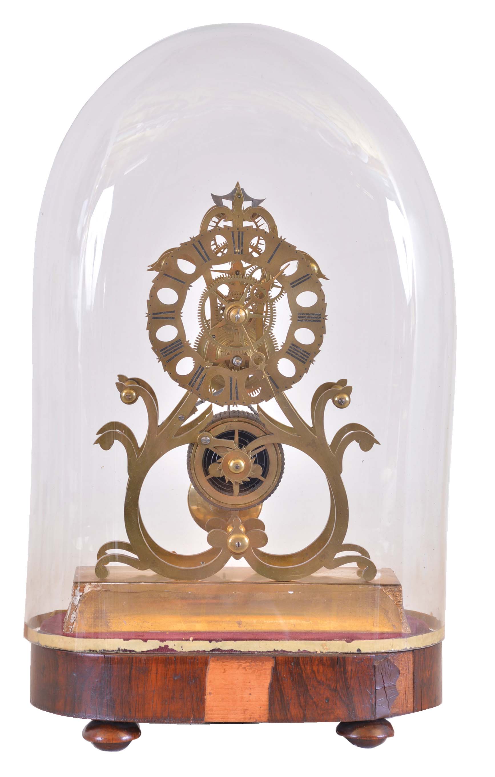 England, skeleton clock, the eight day fusee timepiece with nicely designed and executed scroll frames, the pattern similar to those used by Condliff for their great wheel clocks, Roman numeral brass dial with scalloped edge and oval piercing, brass hands and pendulum, mounted to a gilt plinth, and fixed to a velvet lined, rosewood veneered base with turned feet and dome — Antique Clocks Price Guide