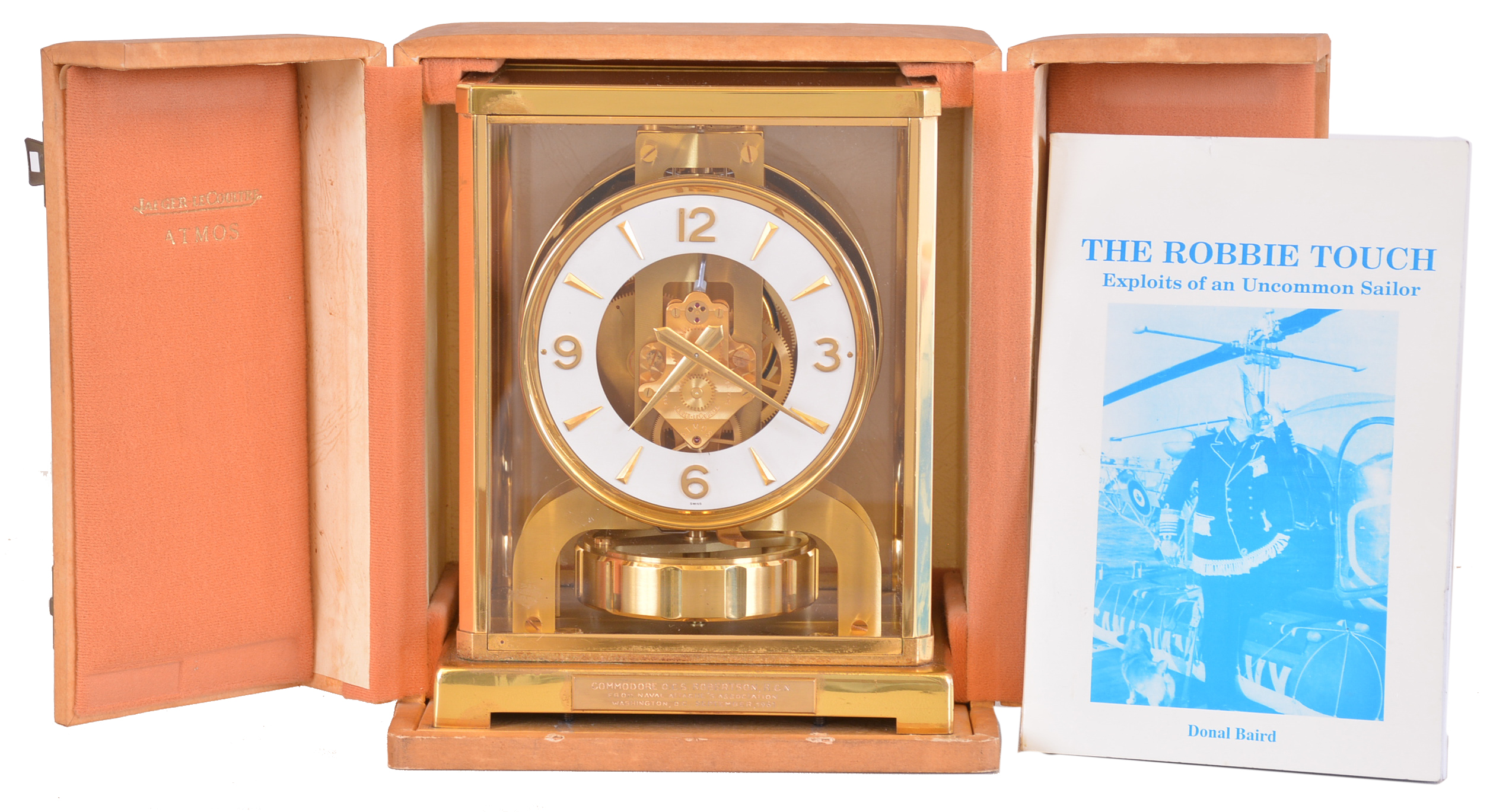 Jaeger- LeCoultre, Switzerland, Atmos clock, glazed, gilt brass case with presentation plaque, "Commodore O.C.S. Robertson, R.C.N. From Naval Attache's Association Washington, D.C. September, 1961", Arabic numeral and arrow marker white painted dial, gilt hands, cal. 526 movement, serial #133975, with original storage case, and a biography of Commodore Robertson — Antique Clocks Price Guide