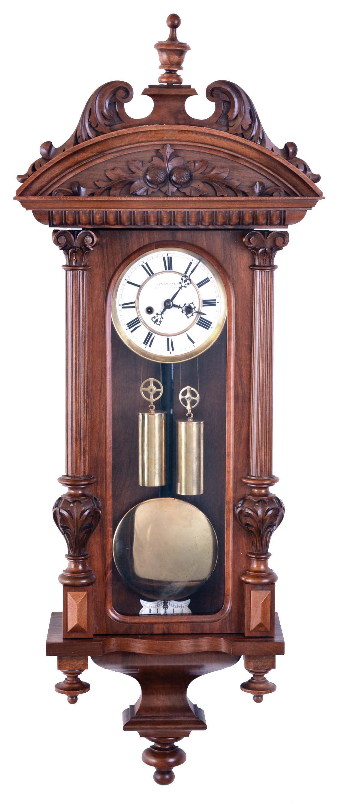 Gustav Becker, Germany, hanging regulator, walnut case with carved and turned ornament, Roman numeral two piece enamel dial signed "Rudholzer Klagenfurt", blued steel hands, weight driven time and strike movement, brass pendulum with wooden rod, and brass weights — Antique Clocks Price Guide