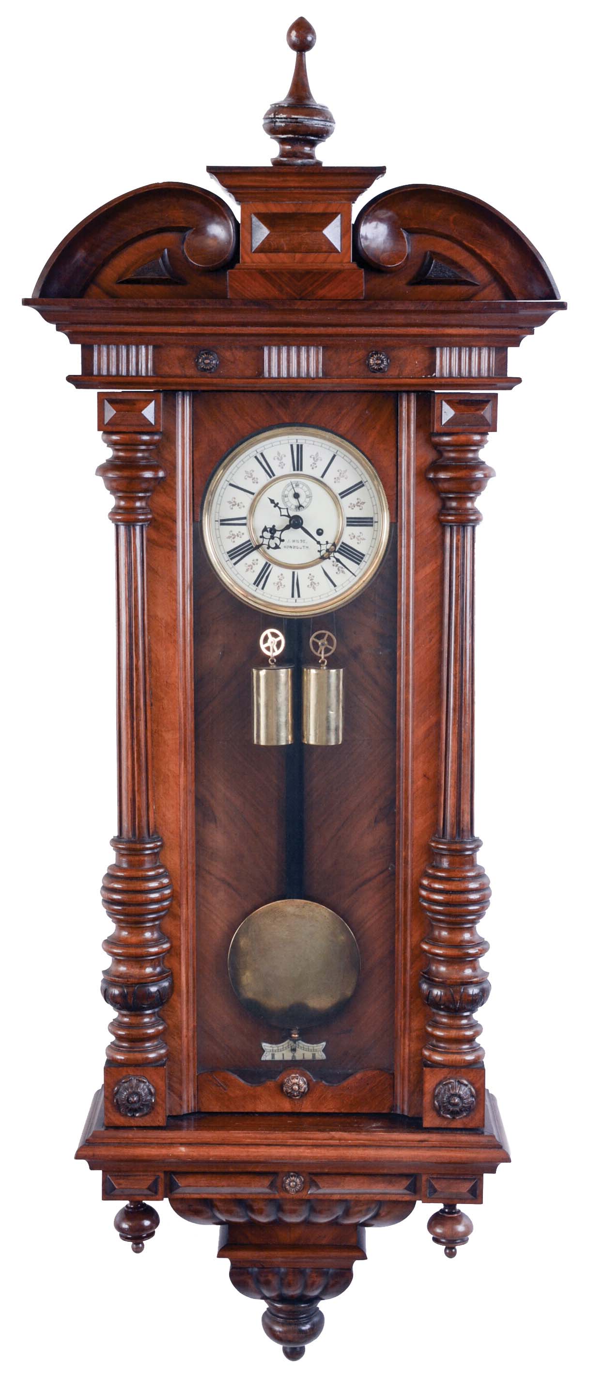Germany, a large hanging regulator, walnut case with turned and carved ornament, turned finial and drops, two piece Roman numeral enamel dial signed "J. Wilde, Monmouth, blued steel hands, 8 day time and strike, weight driven movement, brass pendulum with wooden rod, brass weights — Antique Clocks Price Guide