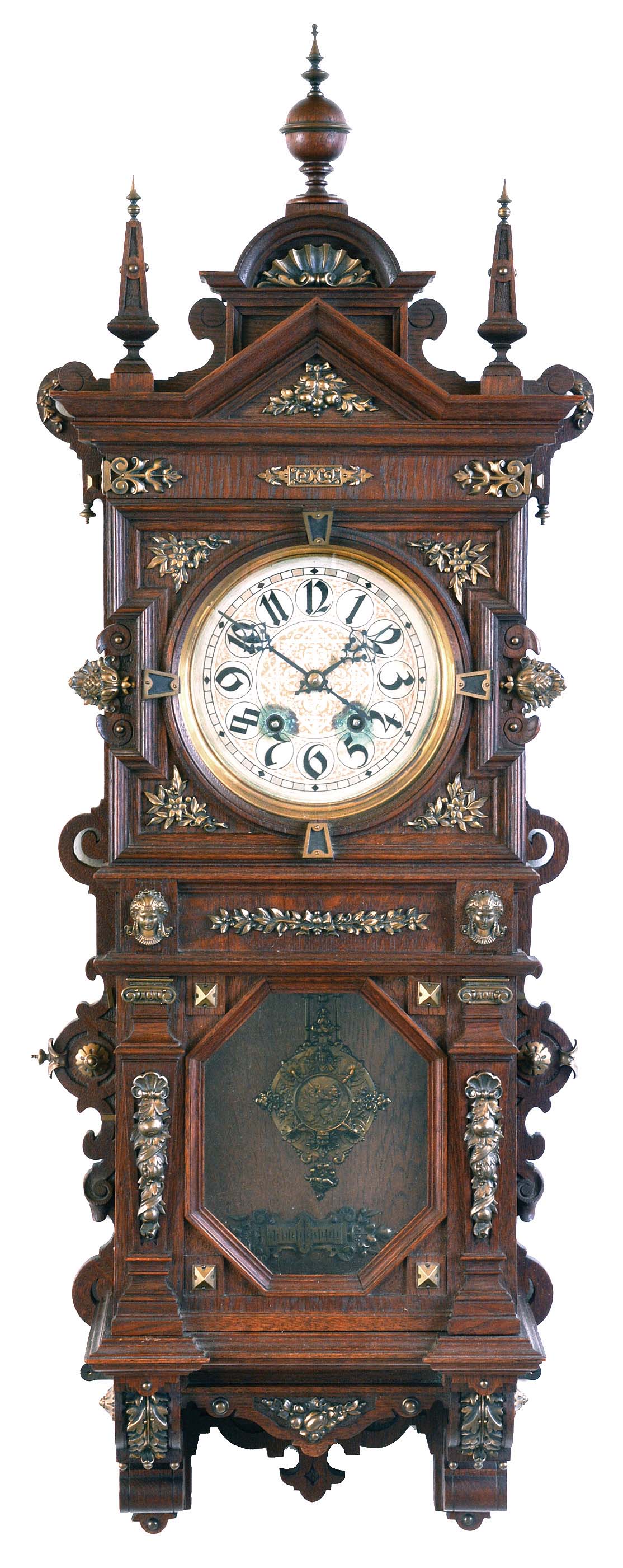 Lenzkirch, Germany, wall clock, the oak case richly ornamented with carving, moldings, and applied, cast brass elements, case top with central sphere and flanking obelisk finials, Arabic numeral silvered dial, blued steel hands, two train, 8 day quarter striking movement chiming on two gongs, fancy cast pendulum, serial #865517 — Antique Clocks Price Guide