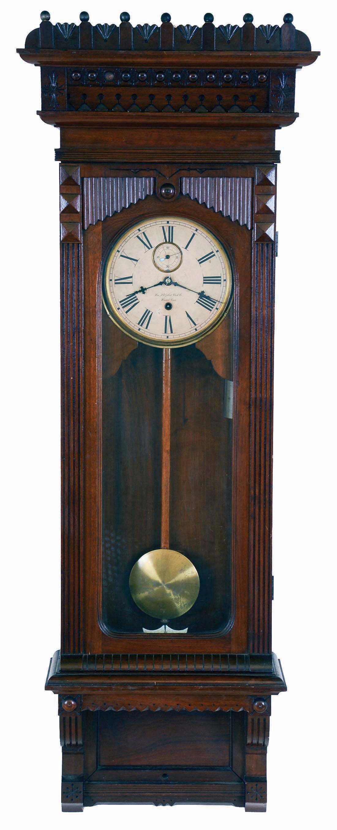 William L. Gilbert Clock Co., Winsted, Conn., "Regulator No. 11" wall hanging clock with an 8 day double weight driven timepiece movement in a walnut case. — Antique Clocks Price Guide