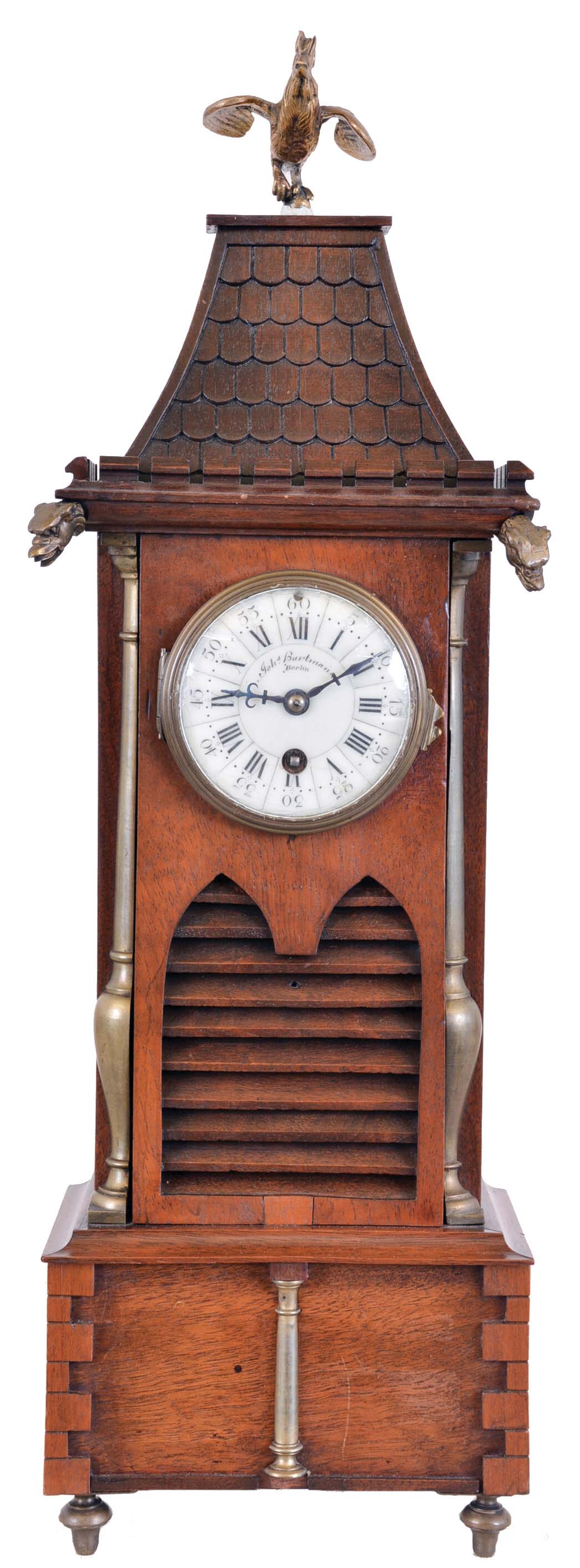 France, for Johs. Hartmann, Berlin, architectural shelf clock in walnut, the base with quoined corners, mid section with louvered lancet arches below the quoined mansard roof with crenellated cornice, gargoyle heads, and crowing cock finial, Roman numeral white enamel dial, blued steel hands, 8 day timepiece movement marked "Z. & Co. Paris" — Antique Clocks Price Guide