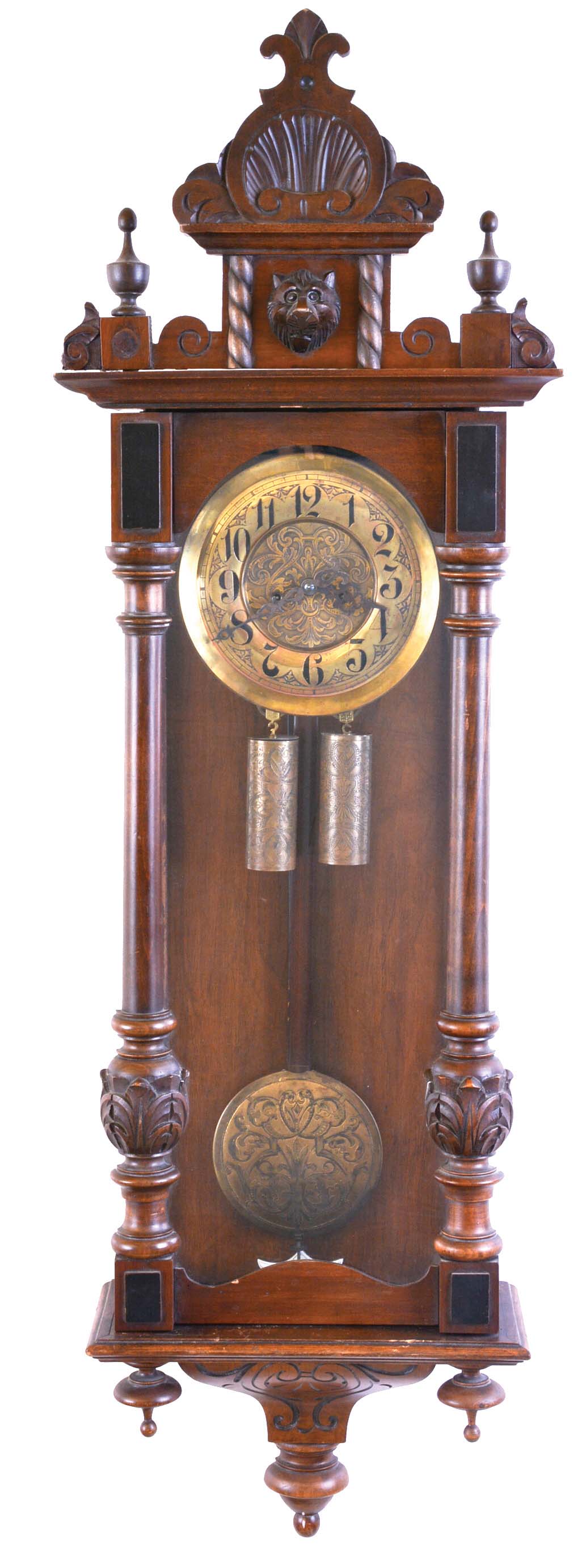 Gustav Becker, Freiburg, Germany, walnut case with turned and carved ornament, Arabic numeral, engraved brass dial, blued steel hands, 8 day time and strike movement, engraved brass pendulum and weights — Antique Clocks Price Guide