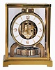 LeCoulture "Atmos" gilt brass and glass perpetual mantel clock, serial number 98063, front door hinges from side, in original green felt carrying box