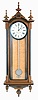 E. Howard & Co., Boston, Mass., "No. 59- 8 Regulator" reissue. Walnut case with ebonized moldings, turned and carved finials, curly maple weight baffle, ebonized wooden bezel with Roman numeral white painted 8" dial, blued steel moon hands, nickel pendulum with silver painted wooden rod, 8 day weight driven timepiece movement, The clock has serial number 275 on the movement and the case and is dated October, 1976.