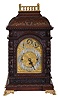 England, unsigned large, three train chiming bracket clock, mahogany case richly ornamented with low and high relief carving, with brass balustrade at top, and resting on gilt paw feet, door with beveled glass, composite dial with Arabic numeral chapter ring, dial plate with engraved center, gilt spandrels, and with rating and chime selection dials in the arch, blued steel hands, substantial 8 day, three train fusee movement chiming on four gongs or eight bells at the quarters, the fourth quarter also with hour striking on a large gong