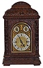 Winterhalder & Hofmeier, Germany, for J.E Caldwell & Co., Philadelphia, a large three train bracket clock, the oak case richly ornamented with low and high relief carving, door with beveled glass, composite dial with Roman numeral chapter ring, matted center, gilt baroque spandrels, and with rating and chime selection dials in the arch, blued steel hands, 8 day, three train fusee movement chiming on four or eight gongs at the quarters, the fourth quarter also with hour striking, and with grand sonnerie repeating on demand
