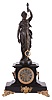 Guilmet, France, mystery clock, black slate case with molded base, foliate side ornaments with lyre form handles, on scroll feet with foliate ornament, surmounted by a patinated female figure, her left hand held aloft, and suspending the pendulum, impulsed through the nearly imperceptible movement of the base on which the she stands, Roman numeral glass dial, blued steel distaff hands, 8 day time and strike movement with crank and stirrup escapement, front plate nickel plated, and with well finished brass and steel work, the back plate with Guilmets mark and numbered 4283