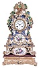 Grohe, a Paris, a three part, rococo style porcelain mantel clock with case by Jacob Petit, the clock and stand both decorated with molded and brightly painted naturalistic ornament, highlighted by bright gilding, all resting on a velvet lined, carved, gilt wooden base, signed Roman numeral white enamel dial, blued steel Breguet style hands, 8 day time and strike pendule de Paris movement with silk thread suspension, stand marked "JP", dial and movement signed