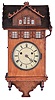 Johann Baptiste Beha, Eisenbach, a rare 8 day "Herrenhausle" hanging cuckoo, the architectural case with curly ash veneer and walnut trim, roof with carved shingles and the sash backed with mirrored glass, Roman numeral painted metal dial, blued steel hands, 8 day, two train fusee movement with wooden plates, heavy brass clad pendulum, and large, full bodied cuckoo