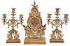 Lenzkirch, Germany, a three piece mantel garniture, ornate cast case with gryphons, masks, and a riot of indescribable ornament, with a pair of three arm candelabra similarly decorated, Roman numeral brass dial, 8 day time and strike movement, serial #414911