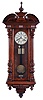 Germany, a large hanging regulator, walnut case with turned and carved ornament, turned finial and drops, two piece Roman numeral enamel dial signed "J. Wilde, Monmouth, blued steel hands, 8 day time and strike, weight driven movement, brass pendulum with wooden rod, brass weights