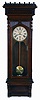 William L. Gilbert Clock Co., Winsted, Conn., "Regulator No. 11" wall hanging clock with an 8 day double weight driven timepiece movement in a walnut case.