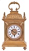 France, gilt bronze desk clock, the decorative case ornamented with fleur de lis, finials, gadrooned cushion to, and carrying handle, Roman numeral white enamel dial, blued steel hands, 8 day timepiece movement with lever platform