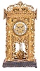 Mantel or table clock, the brass case with elaborate piercing, and applied brass leaves and vines, mounted to a similarly carved wooden base, the overall design seemingly inspired by the carving on Black Forest cuckoo clocks, cast dial with repousse style ornament, and white enamel, Roman numeral cartouches, blued steel hands, and 8 day time and strike pendule de Paris movement, signed Dumoulinneuf Paris