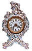 Meissen, Germany, an ornate porcelain mantel clock, the case in pastel colors with gilt accents, with rococo styling and festooned with floral ornament, Roman numeral enamel dial, gilt hands, 8 day time and strike round, French style movement