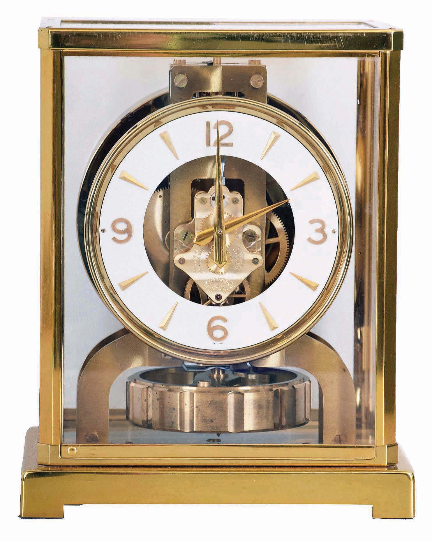 Jaeger LeCoultre, Switzerland, "Atmos" gilt brass and glass perpetual mantel clock, serial number 98063, front door hinges from side, in original green felt carrying box — Antique Clocks Price Guide