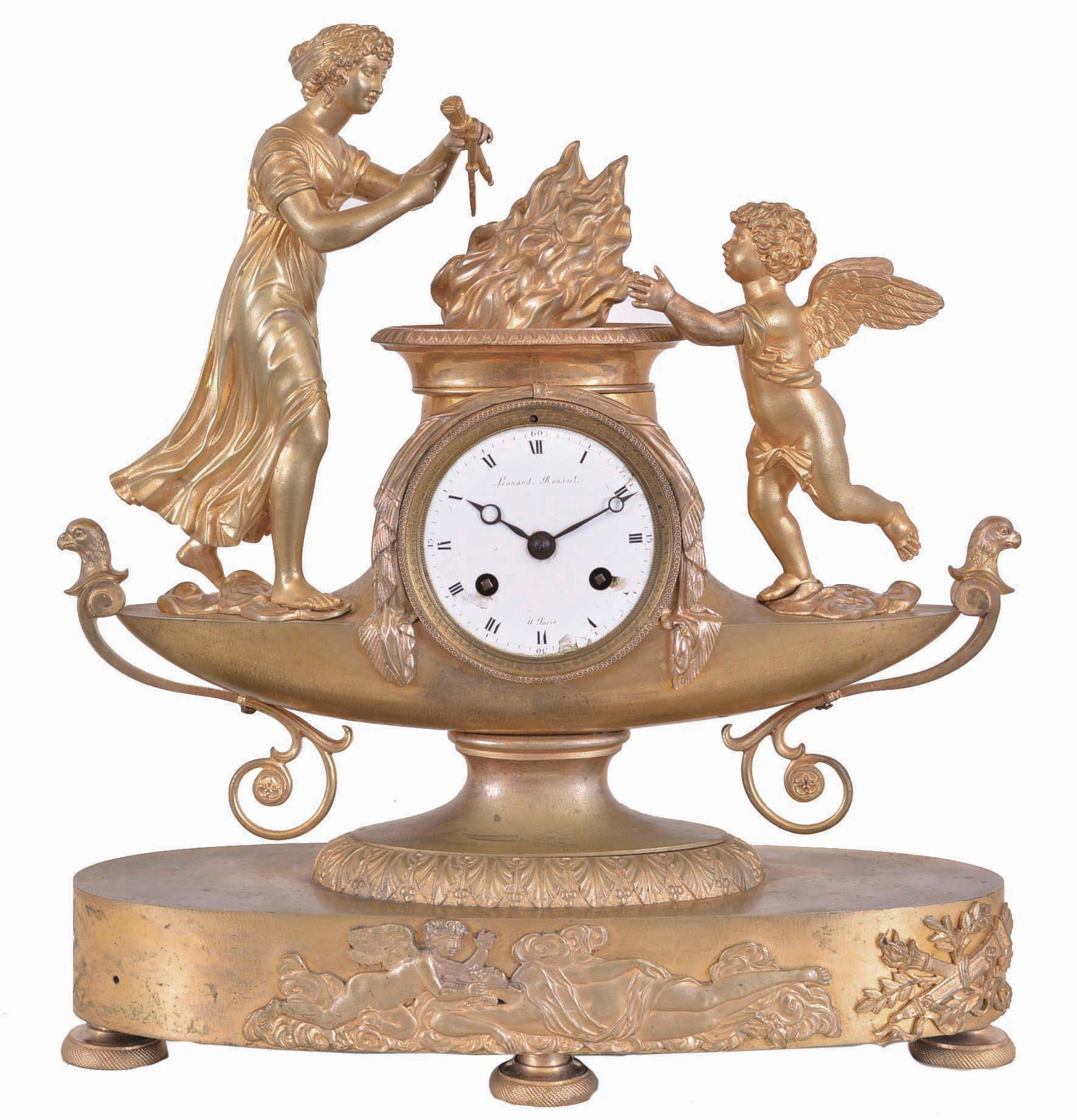 Leonard Rousset, a Paris, a gilt bronze figural mantel clock, the oblong base on engine turned feet with applied cast relief of Cupid and Psyche, supporting the lamp form clock case with figure of Venus casting Cupid's weapons into the fire, signed Roman numeral white enamel dial, blued steel Breguet style hands, 8 day, time and strike pendule de Paris movement with silk thread suspension — Antique Clocks Price Guide