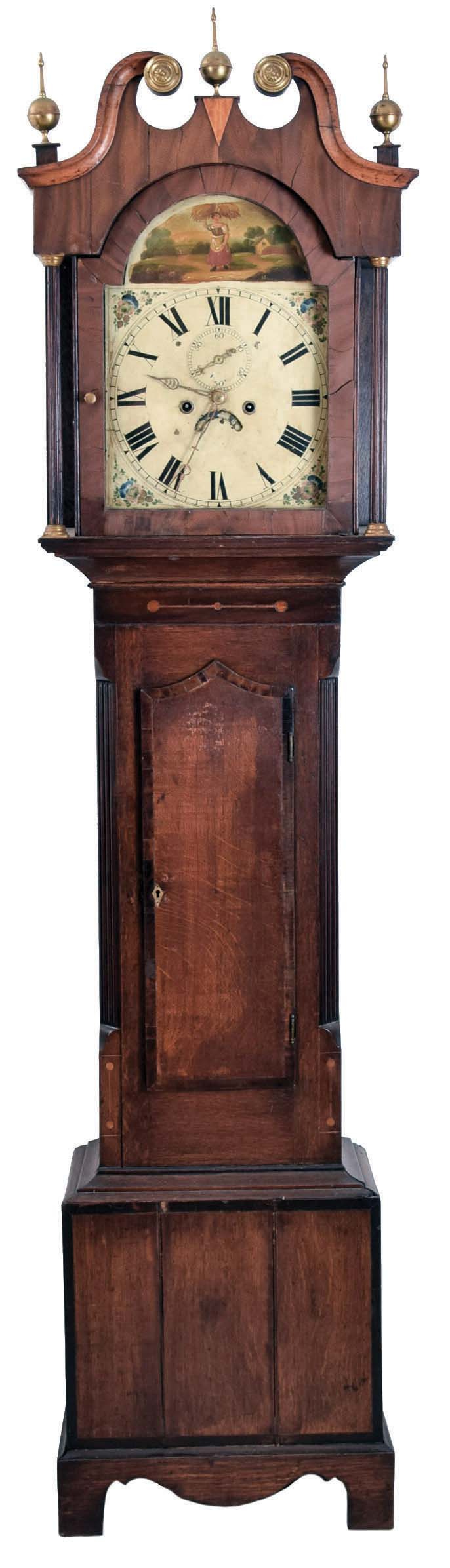 English, 8 day tall clock, time and bell strike, weight driven movement in a mixed veneer/ mahogany inlaid oak case with broken arch top set with brass rosettes and finials, flat reeded pilasters flanking door, painted arch dial with calendar and seconds hand. — Antique Clocks Price Guide