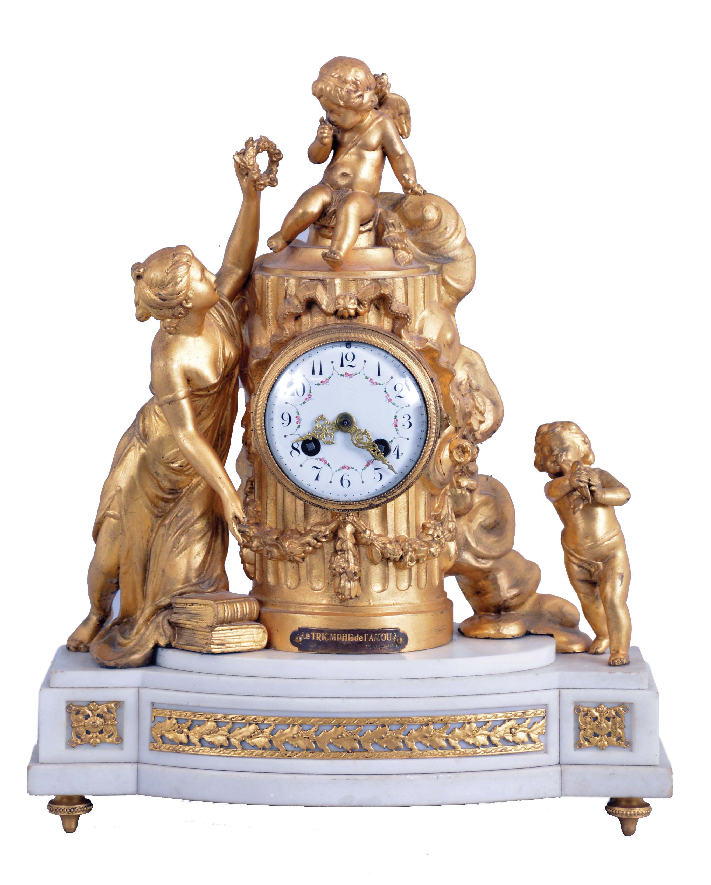 France, gilt spelter and marble figural mantel clock, "Le Triomphe de l'Amour", the stepped, white marble base with bowed front and back, supporting an attenuated, fluted column containing the clock and decorated with floral festoons and trailing ribbon, the female figure at left handing a wreath to the figure of Cupid seated atop the column, and to the right, a standing putto holding a bird, all on gilt, toupie feet, Arabic numeral white enamel dial with polychrome festoons, gilt Louis XV style hands, 8 day pendule de Paris movement — Antique Clocks Price Guide