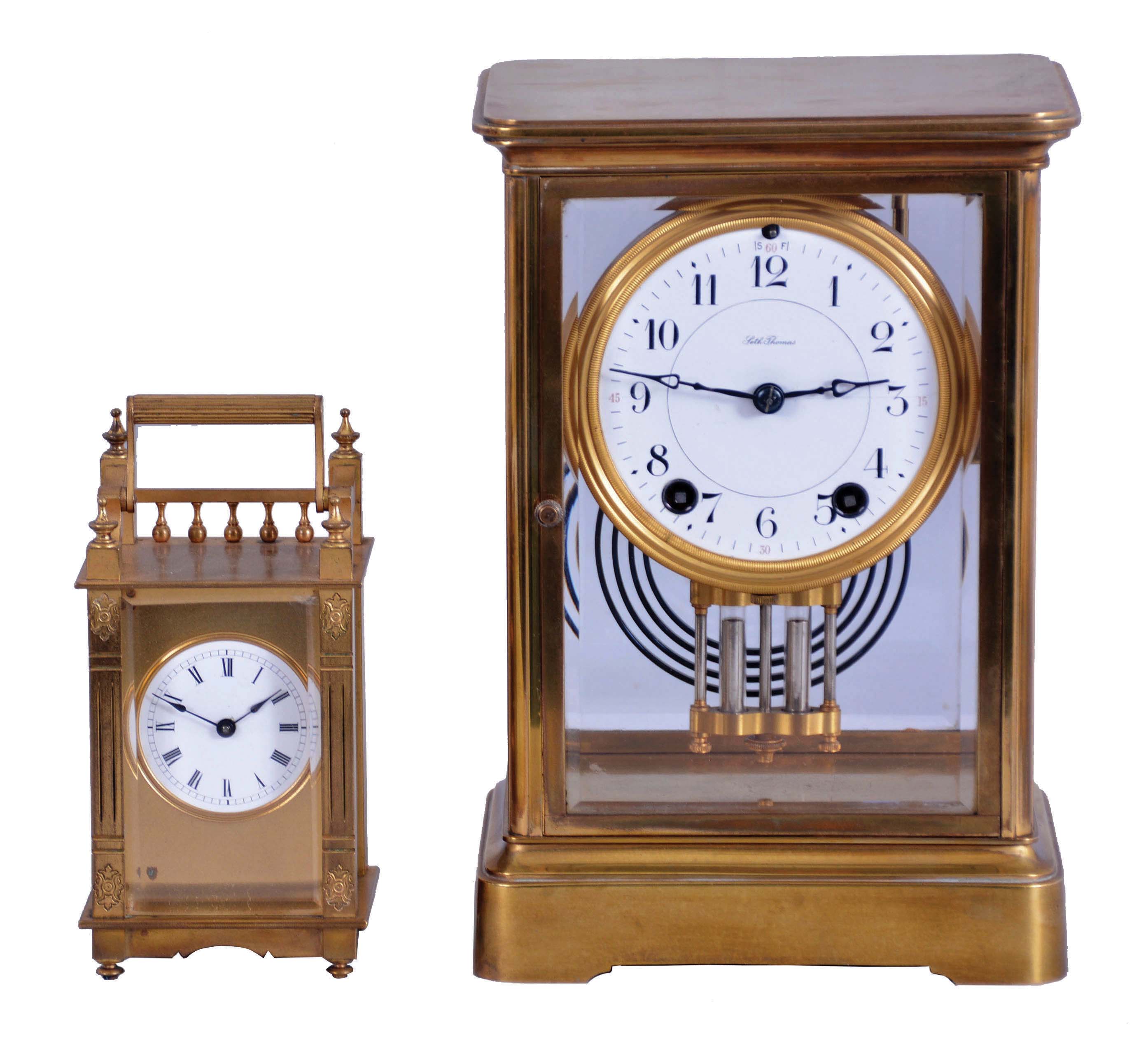 Clocks- 2 (Two) Brass & Glass: (1) Seth Thomas Clock Co., Thomaston, Conn., "Empire No. 200 EXTRA" crystal regulator, 8 day, time and gong strike with round brass movement, c1921. (2) Boston Clock Co., Chelsea, Mass., "Queen Anne" carriage clock, 8 day, timepiece with platform escapement in a gilt brass case with three beveled glasses and white enamel dial showing Roman numerals. Dedicated on the back to "Jeannie", c1890. — Antique Clocks Price Guide