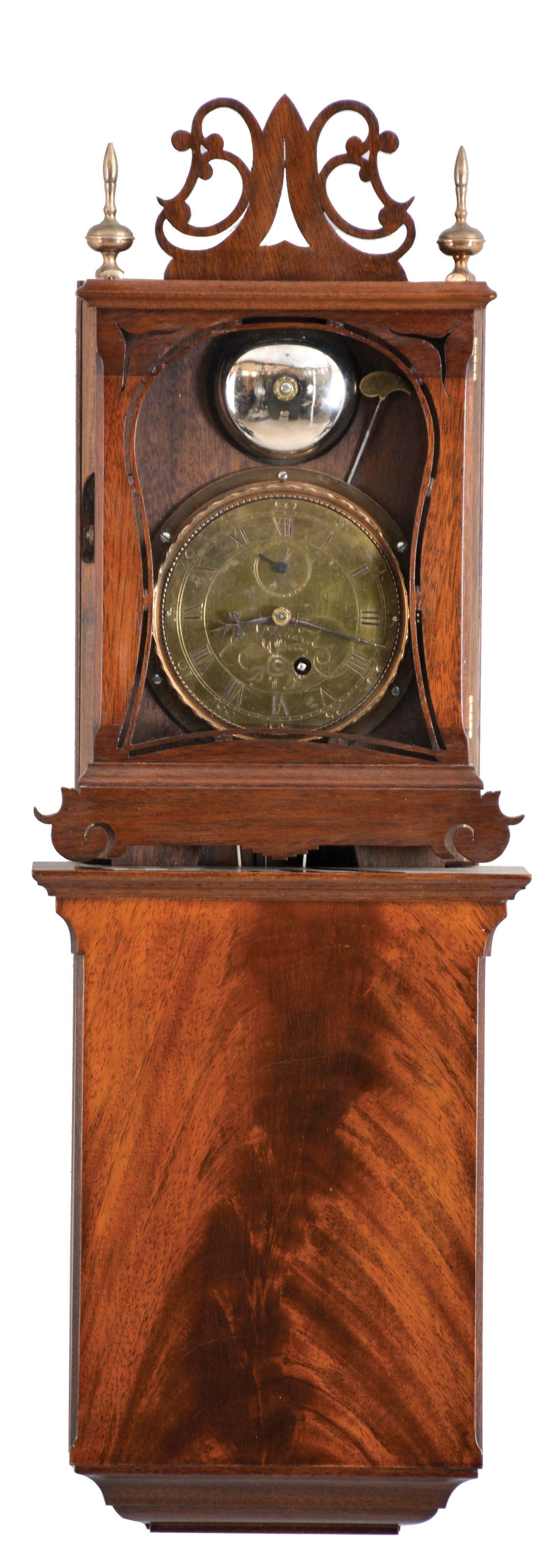 Ted Burleigh Jr., Winchester, Mass., reproduction of an Aaron Willard "Grafton Wall Clock", mahogany case, Roman numeral brass dial, blued steel hands, and 8 day, weight driven timepiece movement. This is number 46 of 50. This timepiece originally retailed for $2,700. The original Willard models only ran 30 hours. — Antique Clocks Price Guide