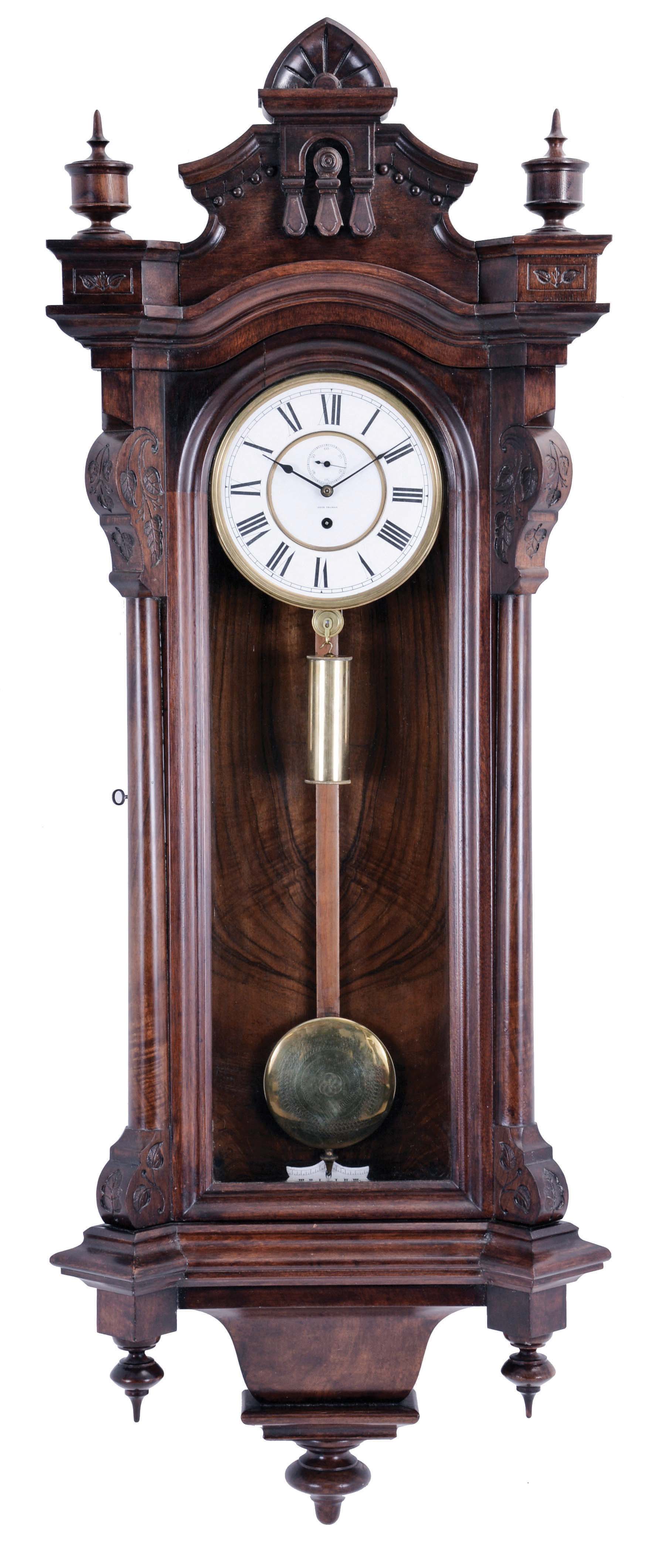 Seth Thomas Clock Co., Thomaston, Conn., "Regulator No. 5" wall clock, solid walnut and burl walnut veneered case, Roman numeral white enamel dial, blued steel spade hands, and weight driven timepiece movement, with maintaining power, brass clad, damascened pendulum, and brass clad weight with knurled caps — Antique Clocks Price Guide