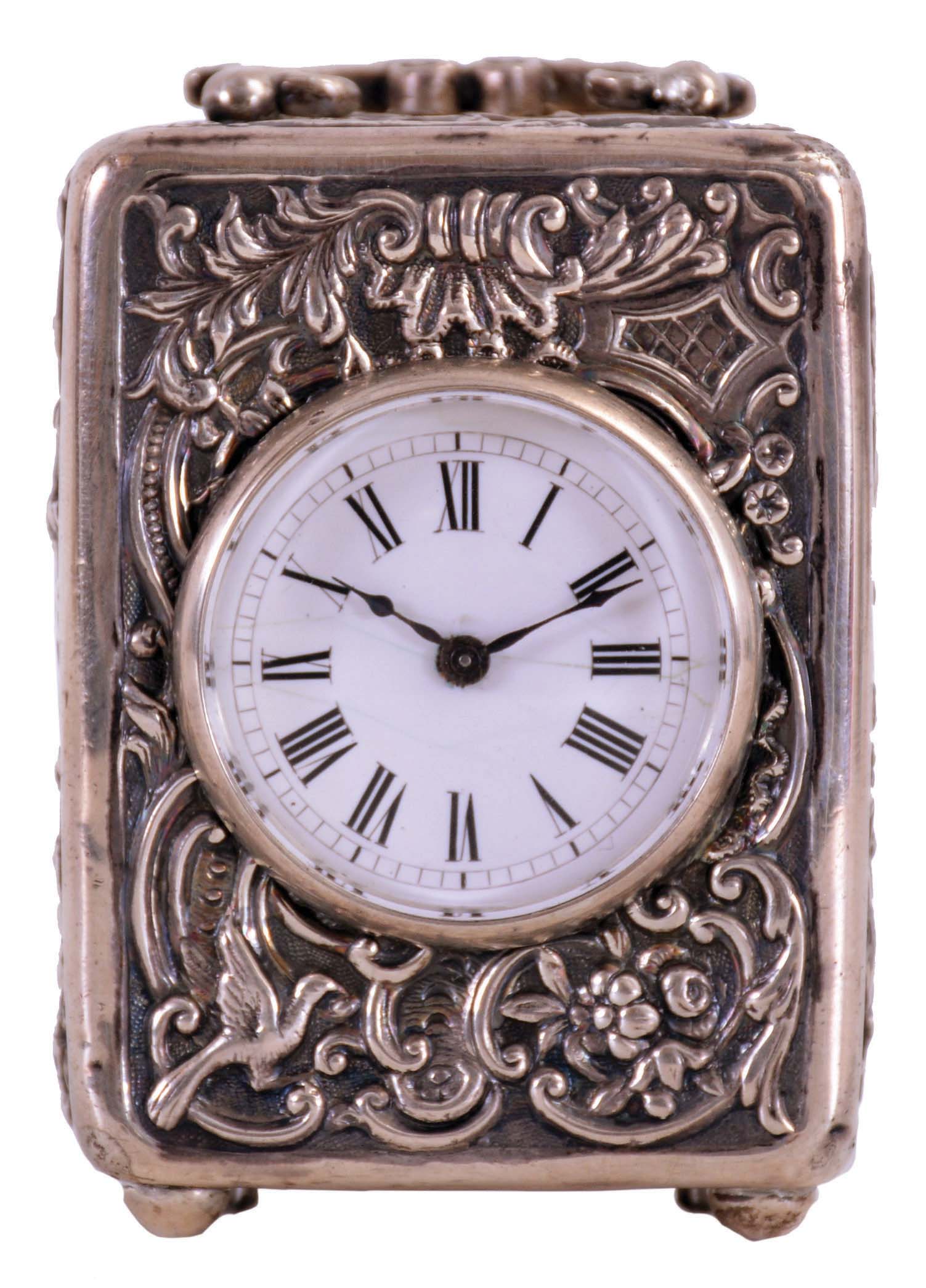 France, small carriage clock, the silver case with repousse ornament in the rococo style, Roman numeral white enamel dial, blued steel hands, 8 day timepiece movement with lever platform — Antique Clocks Price Guide