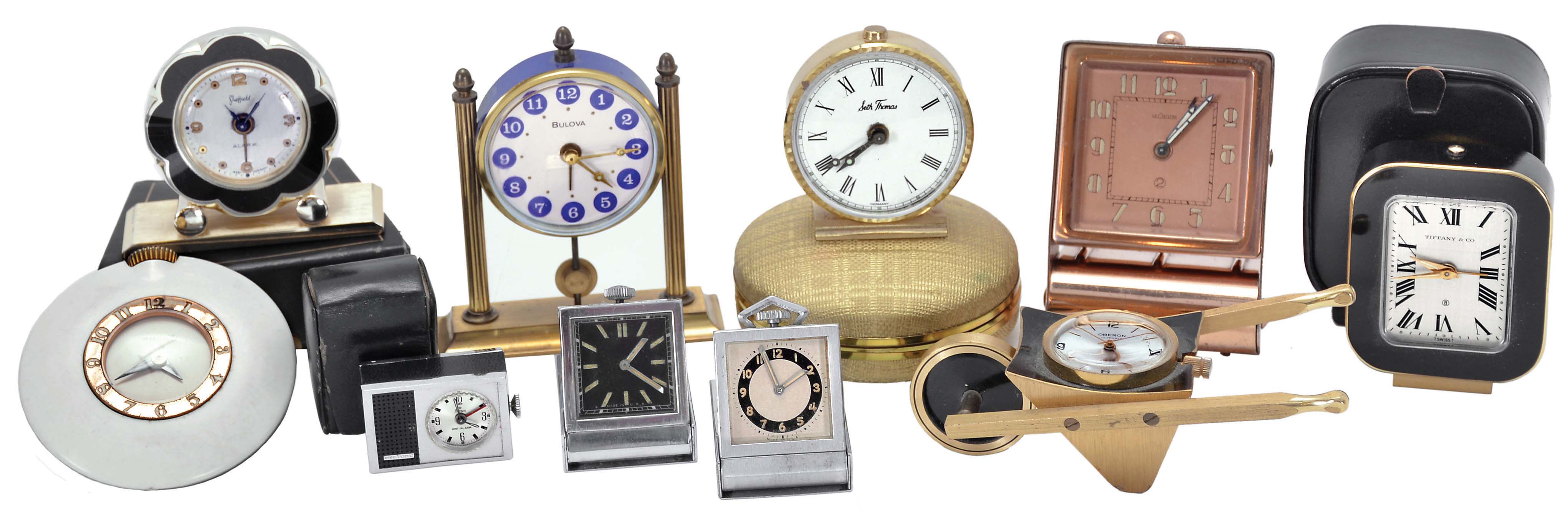 Clocks- 10 (Ten): including a "Tiffany & Co." travel alarm with outer case, an "Oberon" with wheelbarrow form case, a "LeCoultre" travel alarm with folding case, a "Sheffield" travel alarm with outer case, a "Stowa" travel alarm with outer case, two folding purse watches, and others — Antique Clocks Price Guide
