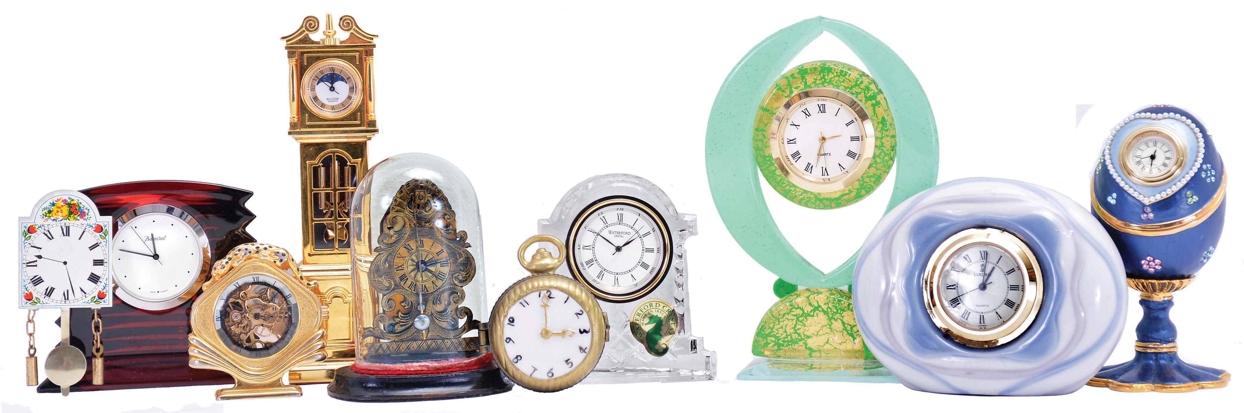 Clocks- 9 (Nine): including one in red Baccarat crystal with original box, one in Murano glass, one in Waterford crystal, a reproduction "Zappler", and others, quartz and mechanical movements, together with a pocket watch form pill case — Antique Clocks Price Guide