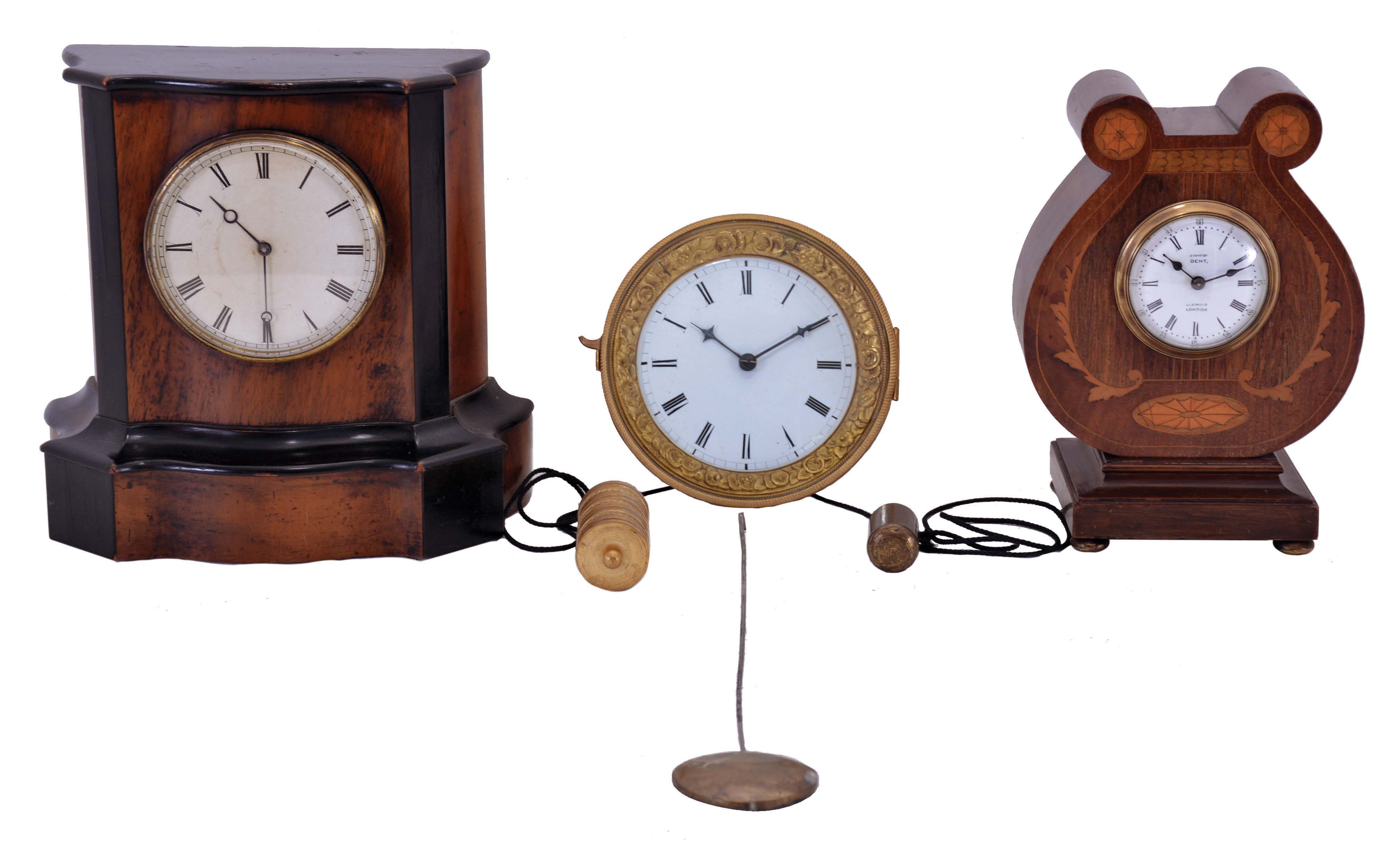 Clocks- 3 (Three): (1) signed "Examined by Dent", lyre form mahogany case with leaf and patera inlay, Roman numeral white enamel dial, French 8 day timepiece movement with platform escapement; (2) an Austrian hook and spike wall clock, gilt bezel with foliate ornament, Roman numeral white enamel dial, and ornamental weight; (3) a small shelf or table clock, walnut veneer case with ebonized moldings, Roman numeral paper dial, 8 day timepiece movement — Antique Clocks Price Guide